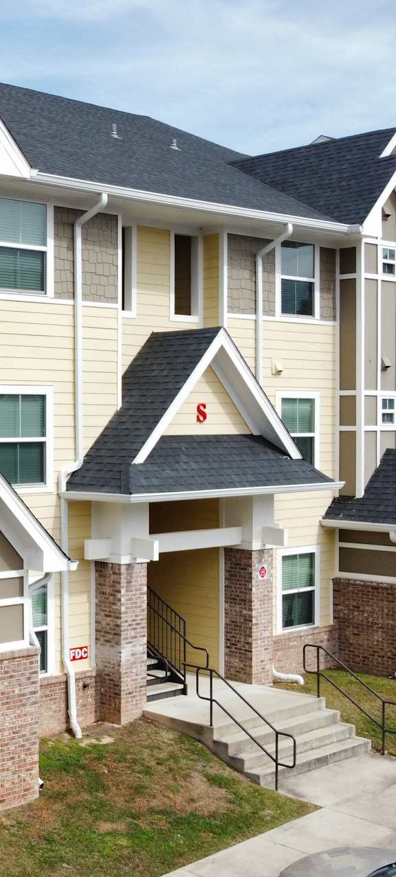 Apartment complex with multiple buildings and balconies.